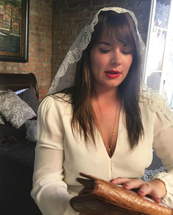 bride getting ready sleek wedding dress and mantilla veil