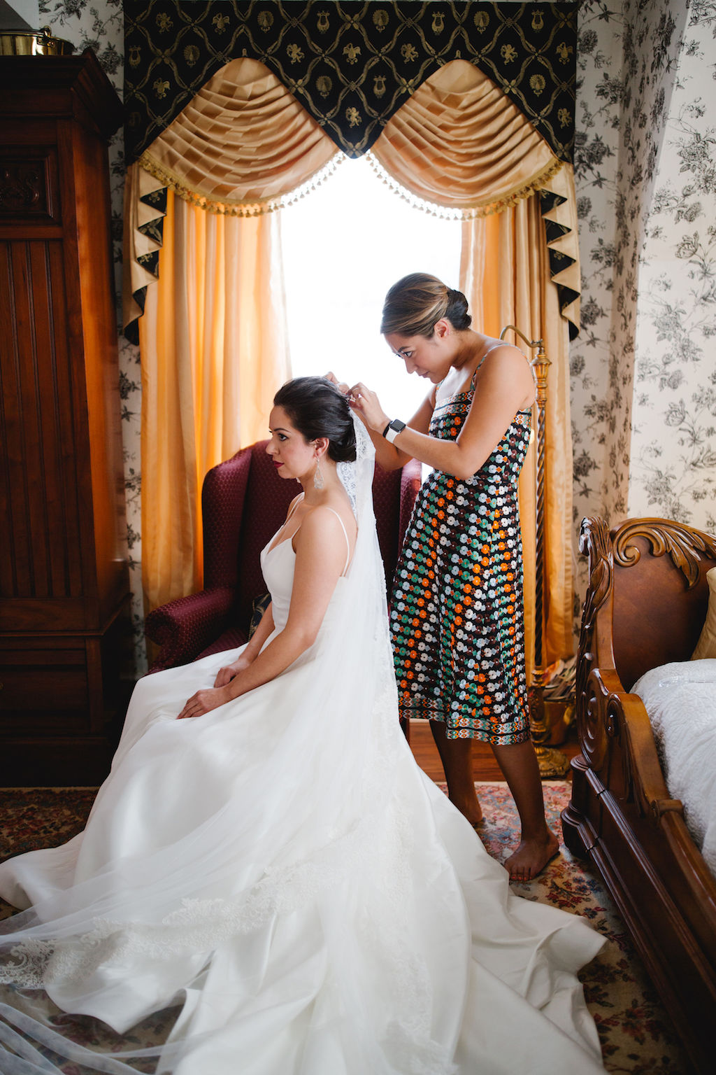 bride putting on veil