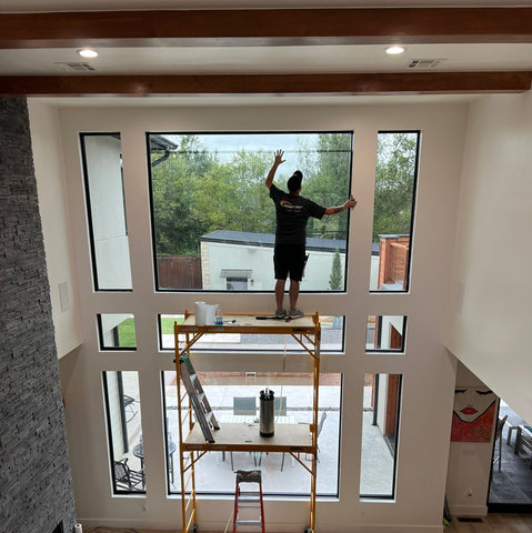 Man installing window film in a residential building
