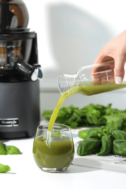 pouring green juice in glass