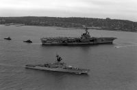 The frigate USS MCCLOY (FF 1038) passes the aircraft carrier USS FORRESTAL (CV 59) while taking part in the parade of ships at the start of Fleet Week.<br>- 1989