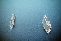 An aerial stern view of the amphibious assault ship USS WASP (LHD-1), left, and the aircraft carrier USS FORRESTAL (CV-59) underway during the NATO exercise Display Determination '91.
<br>- 1991 
