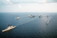 The guided missile cruiser USS BELKNAP (CG-26), lower left, steams at the front of the battle group assembled for the NATO exercise Display Determination '91. Behind the BELKNAP is the guided missile cruiser USS YORKTOWN (CG-48), upper left. In the third rank are, from left: the British light aircraft carrier HMS INVINCIBLE (R-05), the aircraft carrier USS FORRESTAL (CV-59), the amphibious assault ship USS WASP (LHD-1) and the Spanish aircraft carrier PRINCIPE DE ASTURIAS (R-11).<br>- 1991