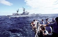 Crew members of the battleship USS IOWA (BB-61) look out over the rail as the guided missile cruiser USS HORNE (CG-30) sails by. - 1987