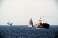 A starboard bow view of ships from tanker convoy No. 12 underway in the gulf. Included in the convoy are the reflagged tanker GAS KING, the guided missile cruiser USS WILLIAM H. STANDLEY (CG-32) and the amphibious assault ship USS GUADALCANAL (LPH-7). - 1987