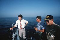 Persian Gulf. Secretary of the Navy James H. Webb Jr., left, talks with a crewman and the ship's commanding officer during a visit aboard the guided missile cruiser USS WILLIAM H. STANDLEY (CG 32). Webb is visiting ships assigned to the Persian Gulf. - 1987