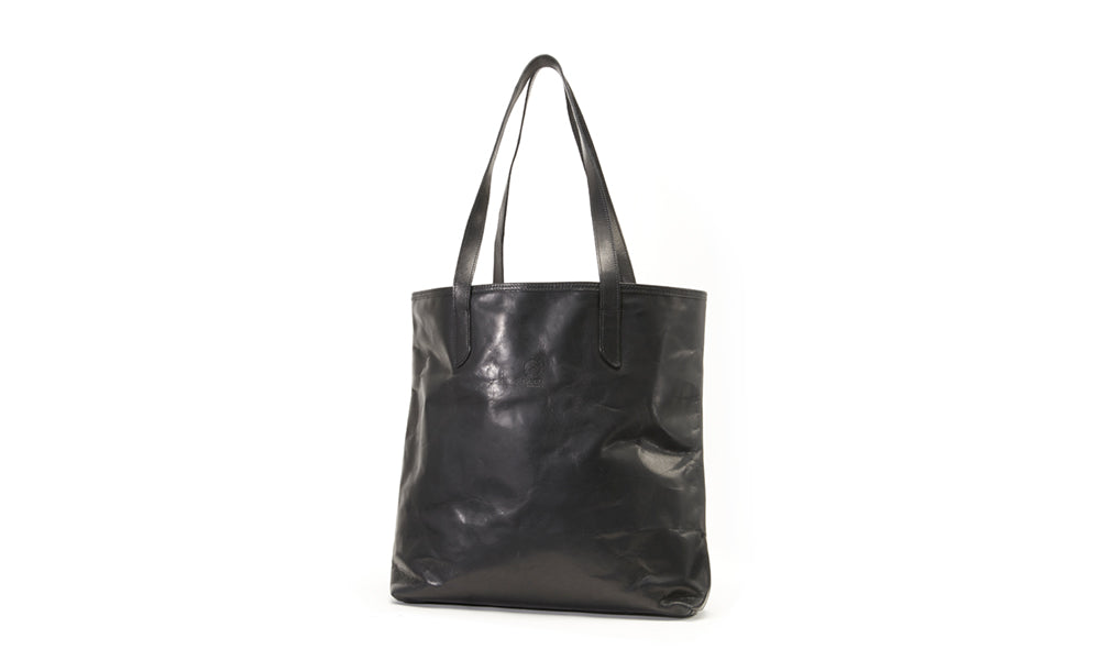 Vertical lightweight tote bag made from a single piece of leather.