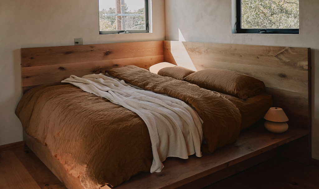 Wood platform bed with linen bedding