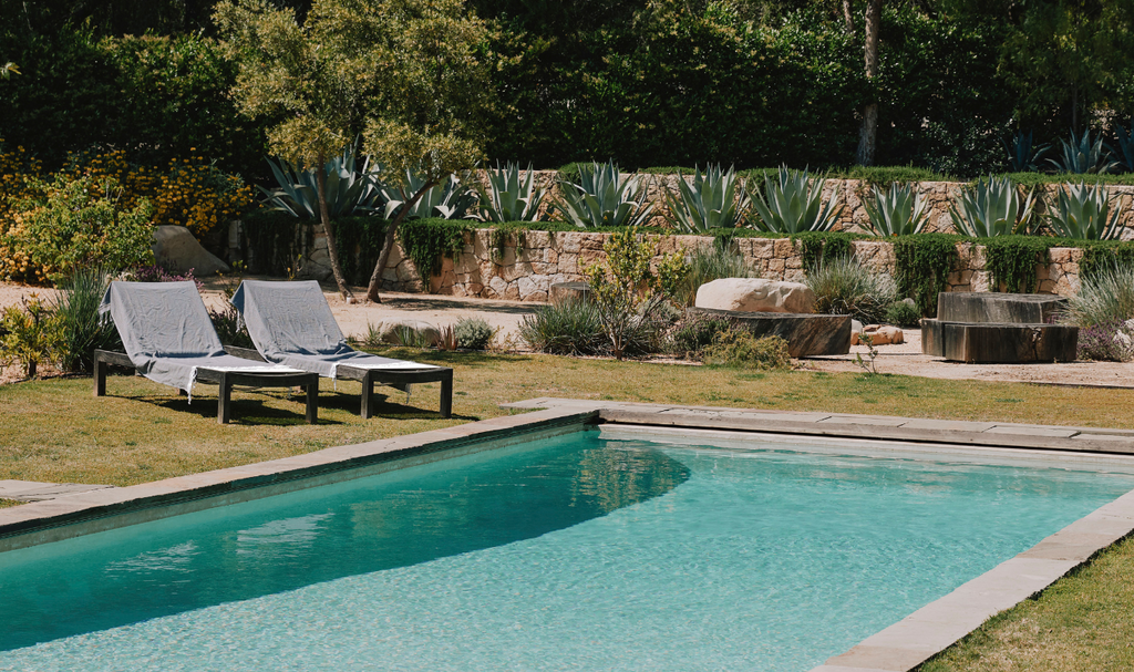 Pool with lounge chairs and beach towels