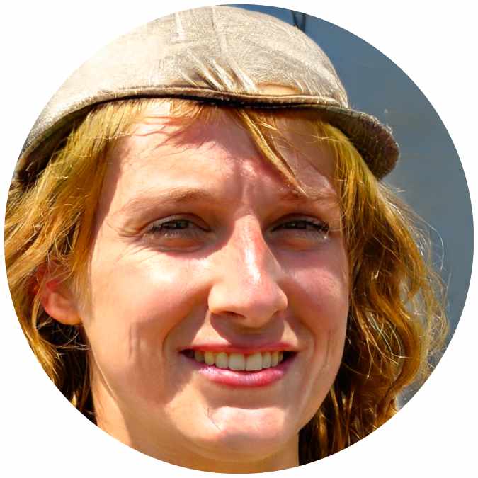 Close-up of a smiling woman wearing a cap.