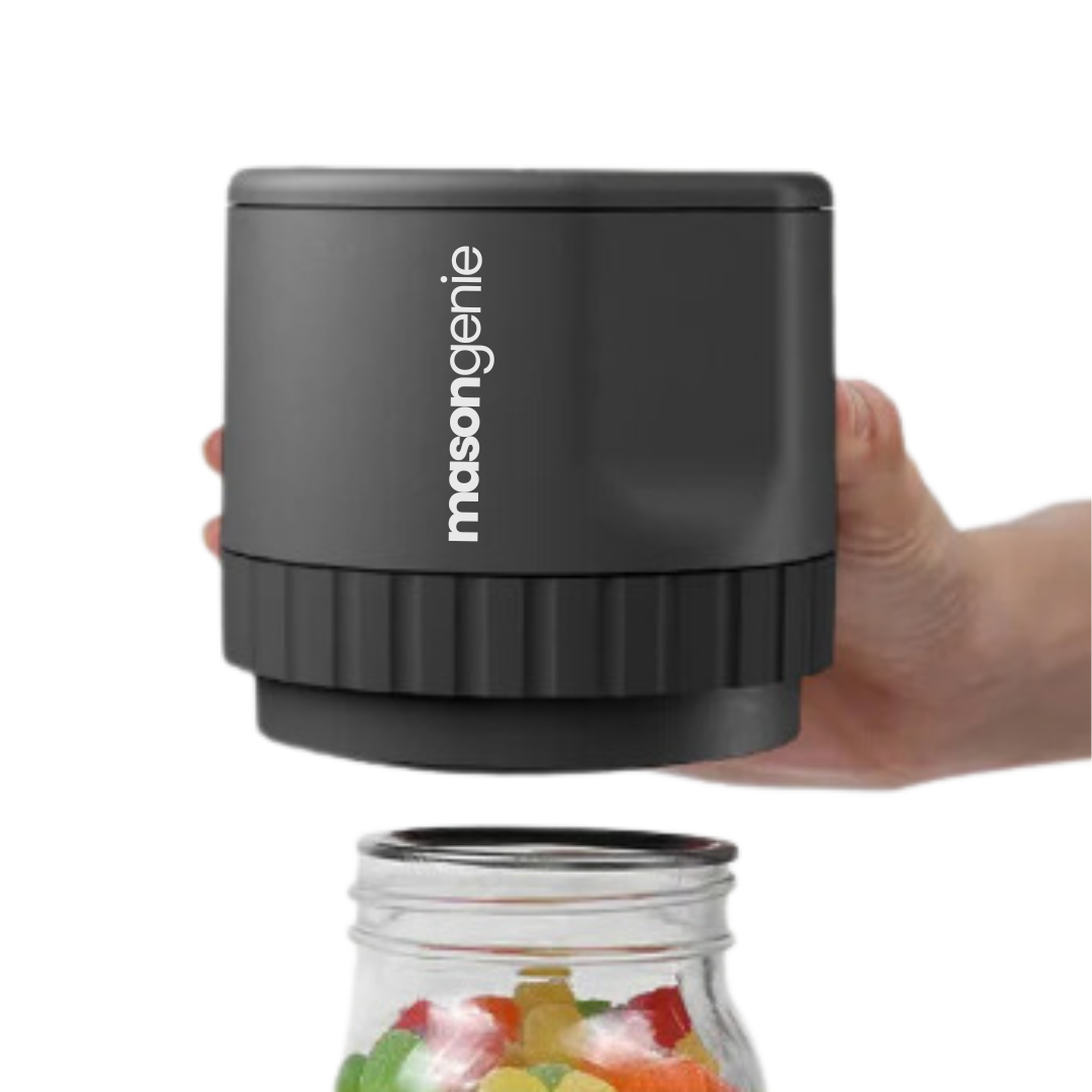 A hand holding a black mason jar accessory labeled 'masongenie' over a jar of salad.