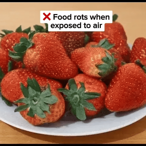 Plate of fresh strawberries with a red cross and text indicating a food myth about air.