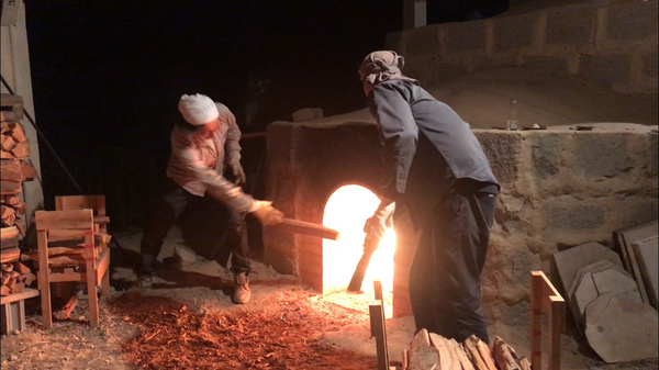 Masanori Makino adding wood to his woodfire kiln in Hagi, Japan