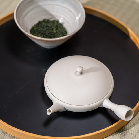 A Japanese teapot and bowl of Japanese tea on a tray