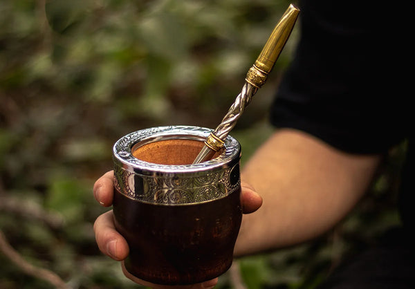 Persona sosteniendo un mate con una bombilla