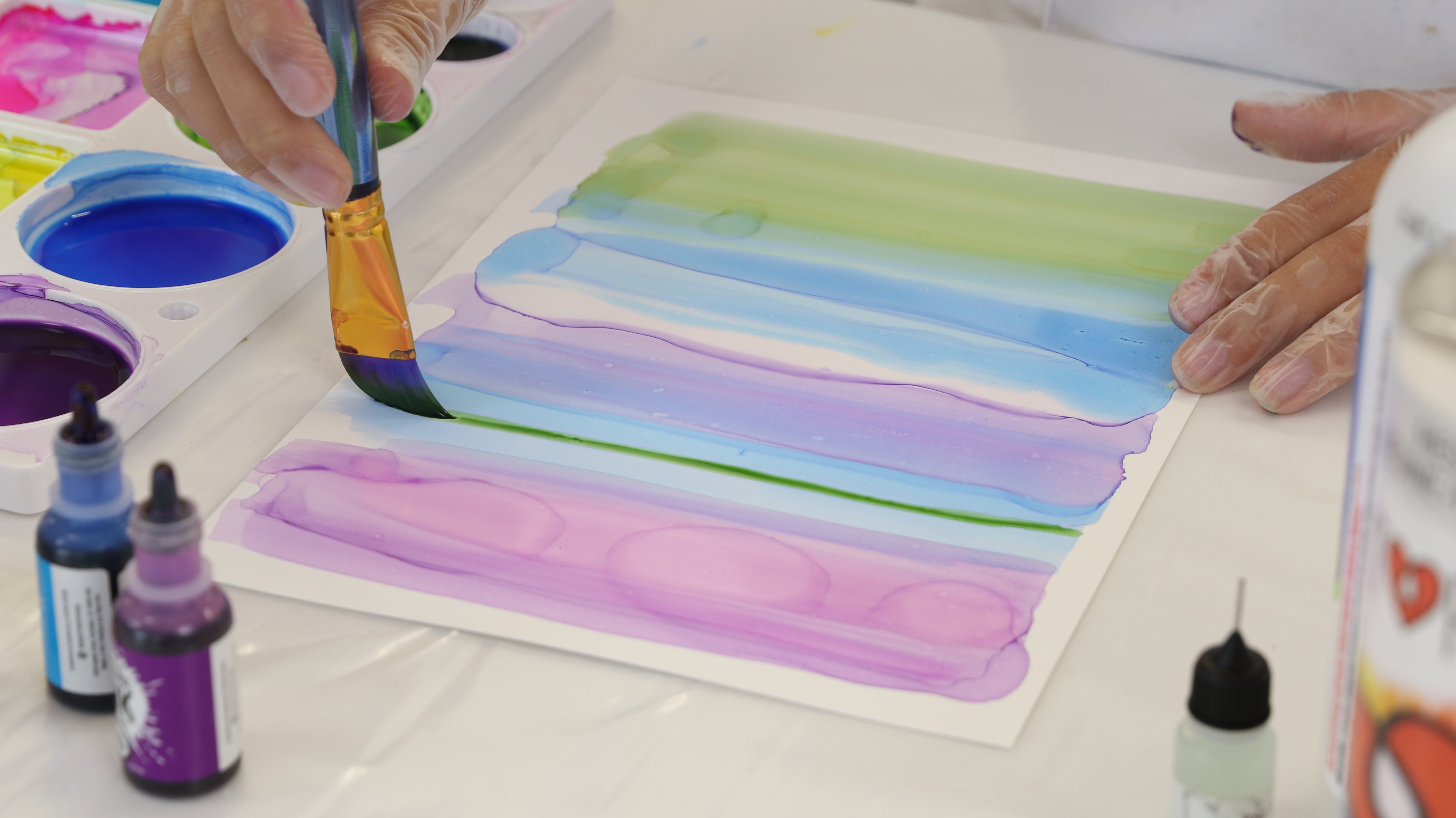 brushing alcohol ink onto yupo paper