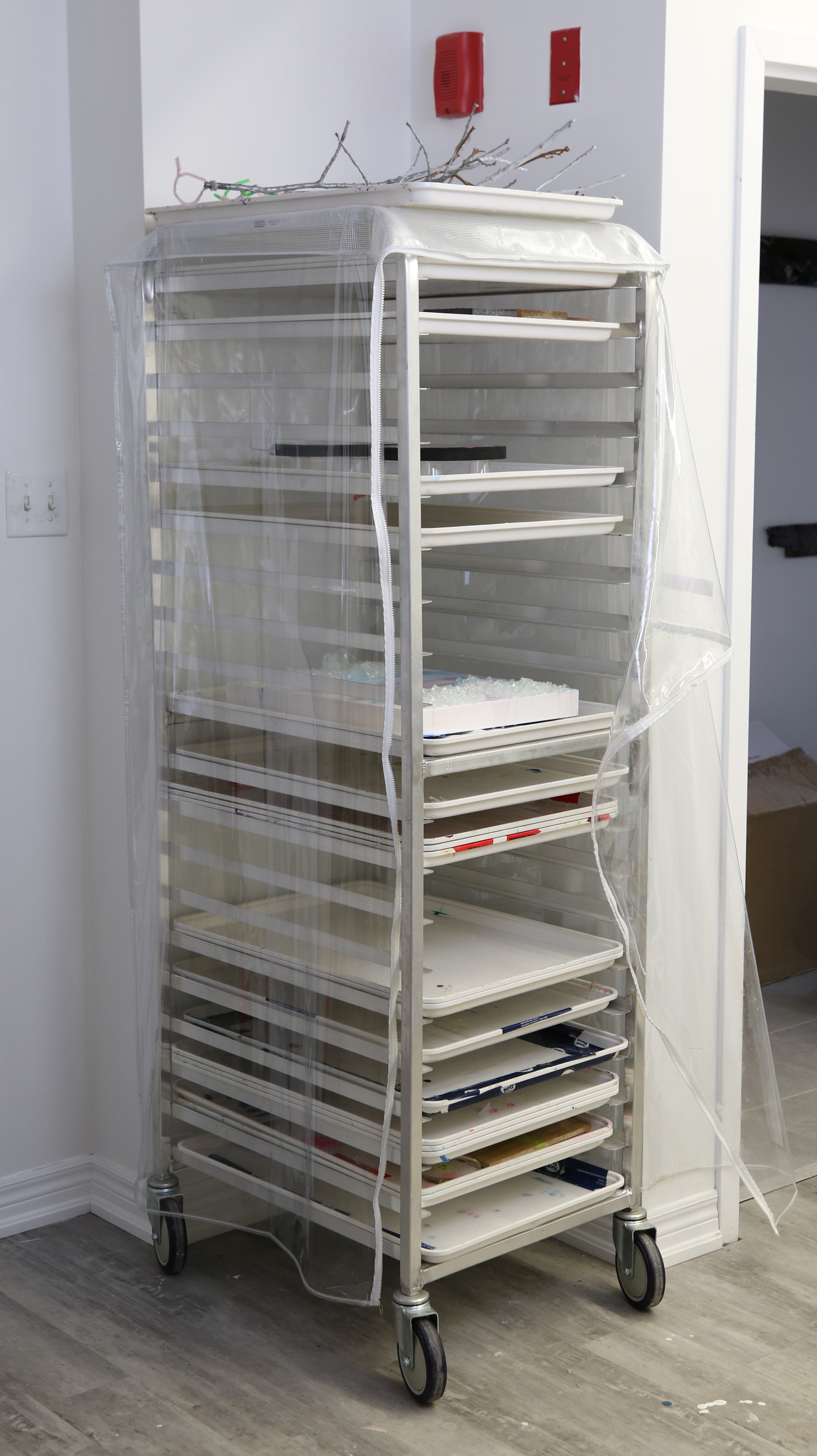 a baker's rack is a great for storing resin art while it cures