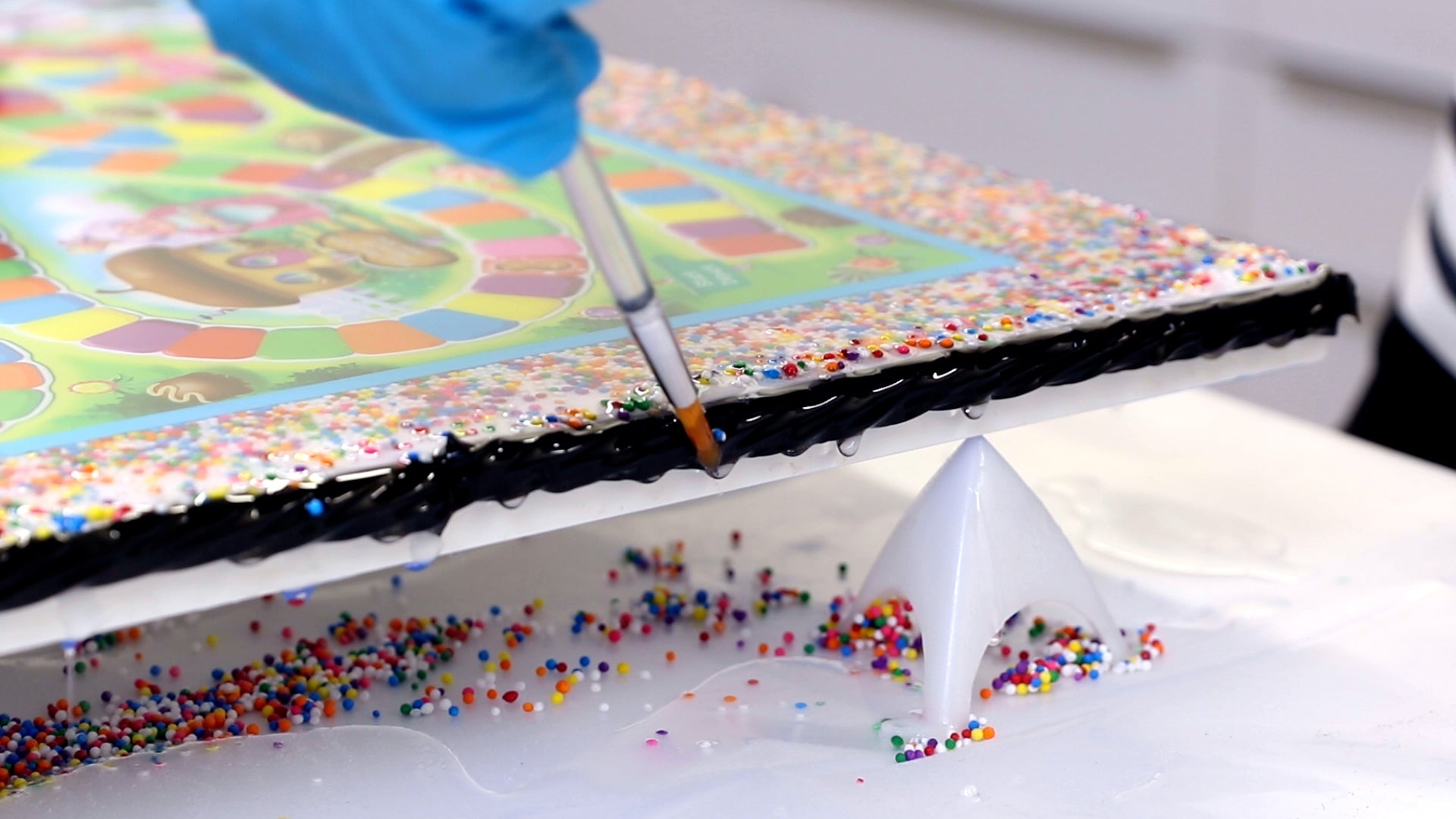 use a brush or toothpick to move sprinkles that have shifted in resin