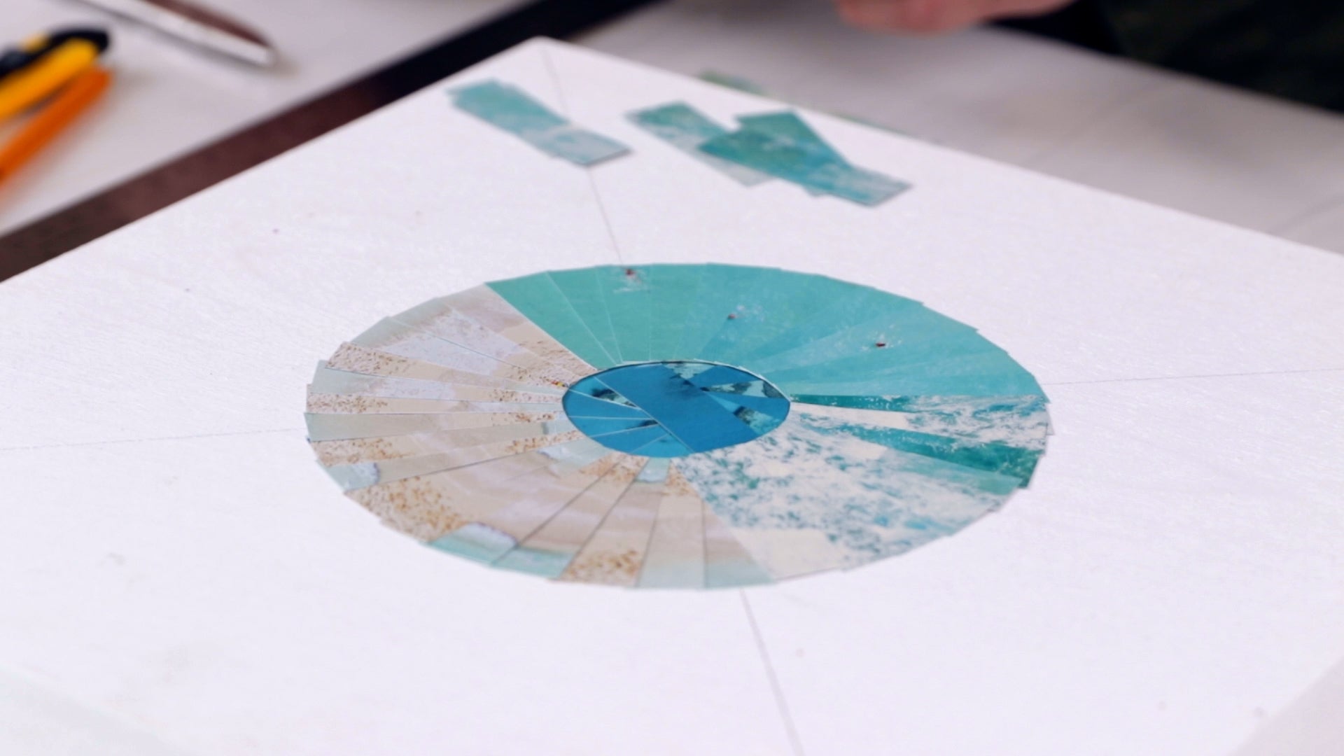 how to resin a paper collage: build out circles made up of strips of paper