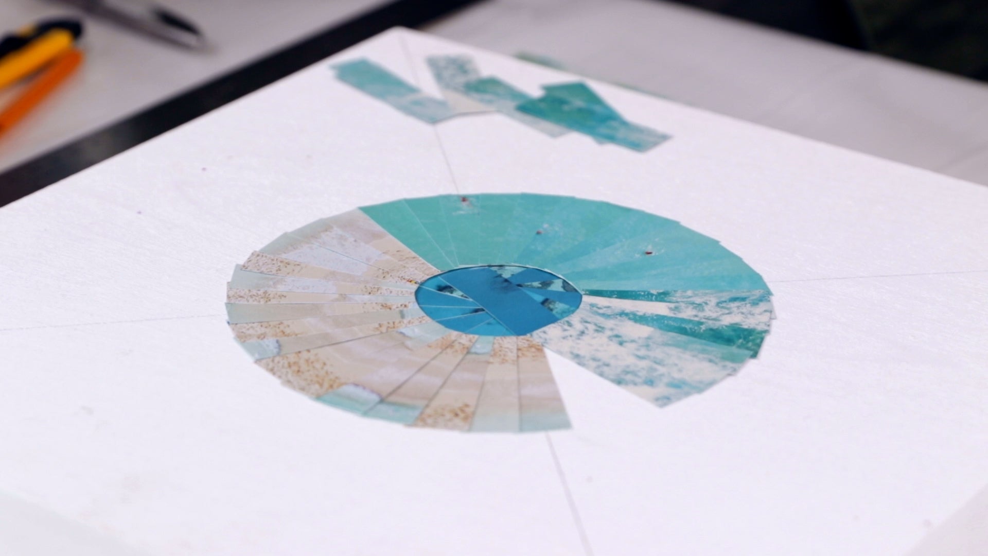 how to resin a paper collage: placing paper down onto a panel to create a collage