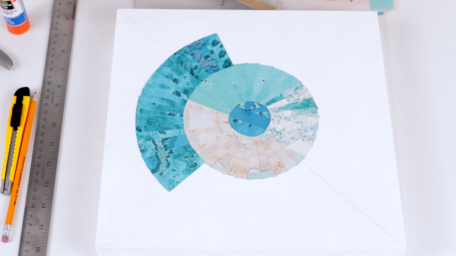 how to resin a paper collage: start the third circle with a dark turquoise pattern