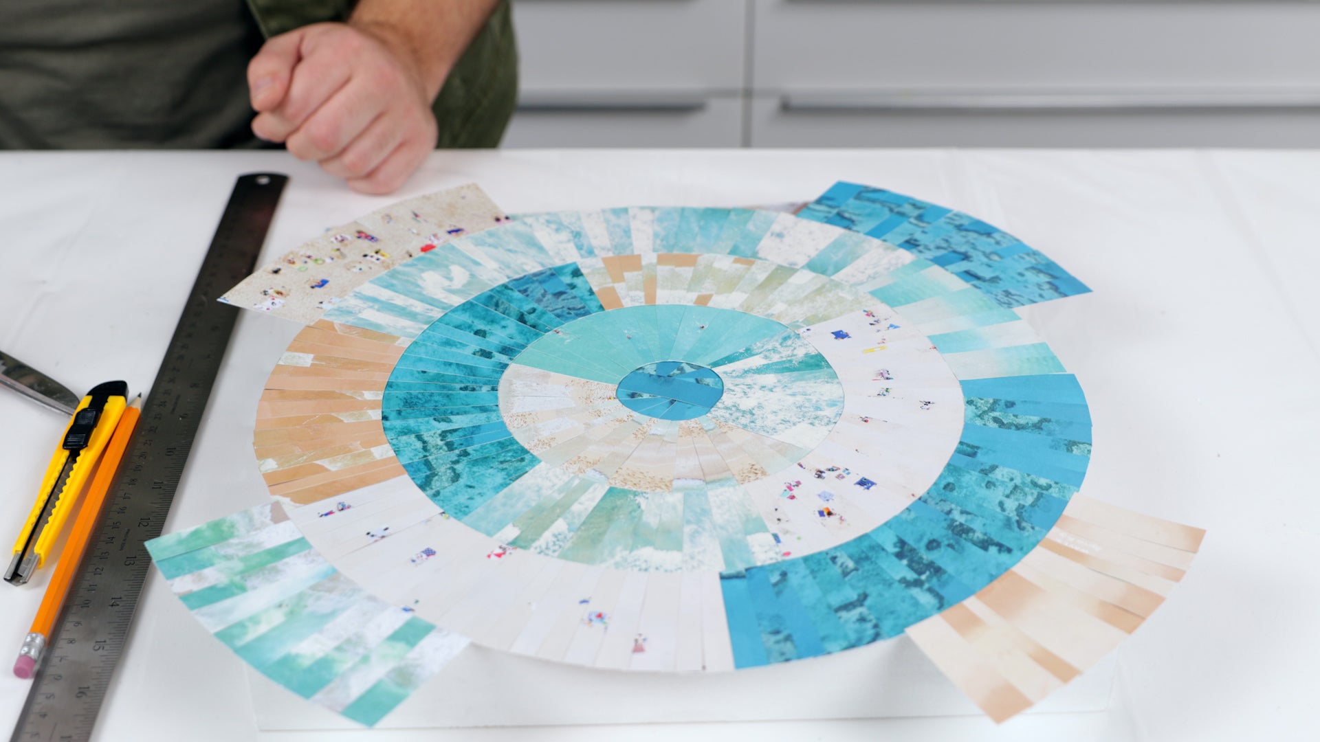 how to resin a paper collage: paper is laid down and ready for excess to be trimmed