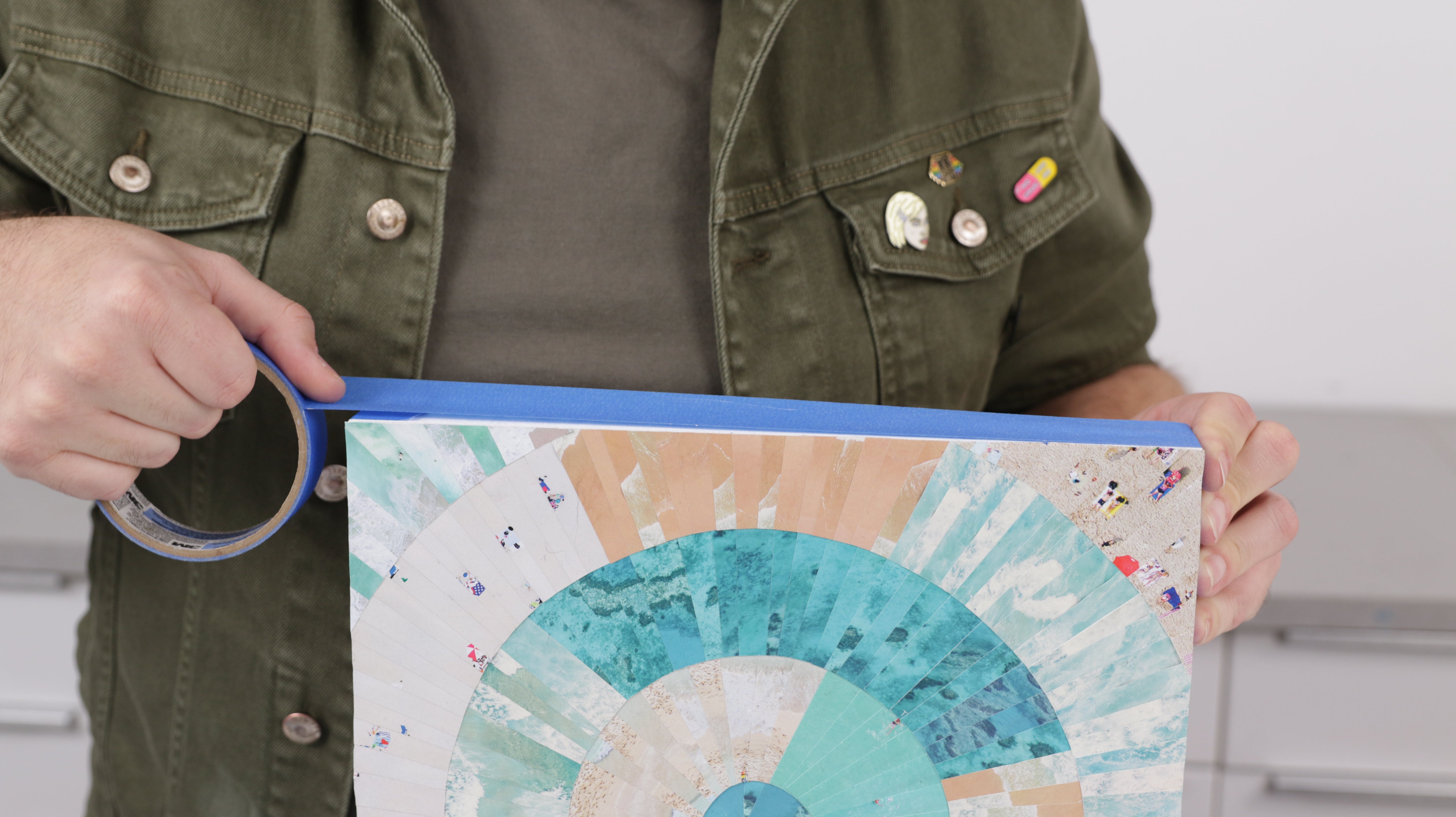 how to resin paper collage art: tape off the edges of the panel to protect from resin