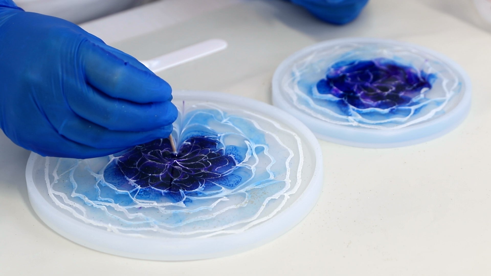 drag toothpick across 3D resin flower design to shape the petals