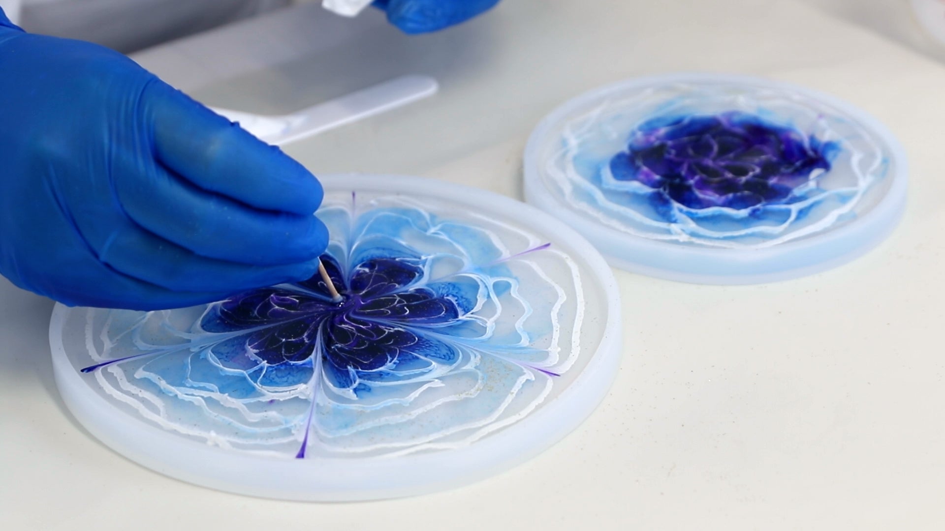 shape the flower petal in resin 3D flower by dragging toothpick through the resin