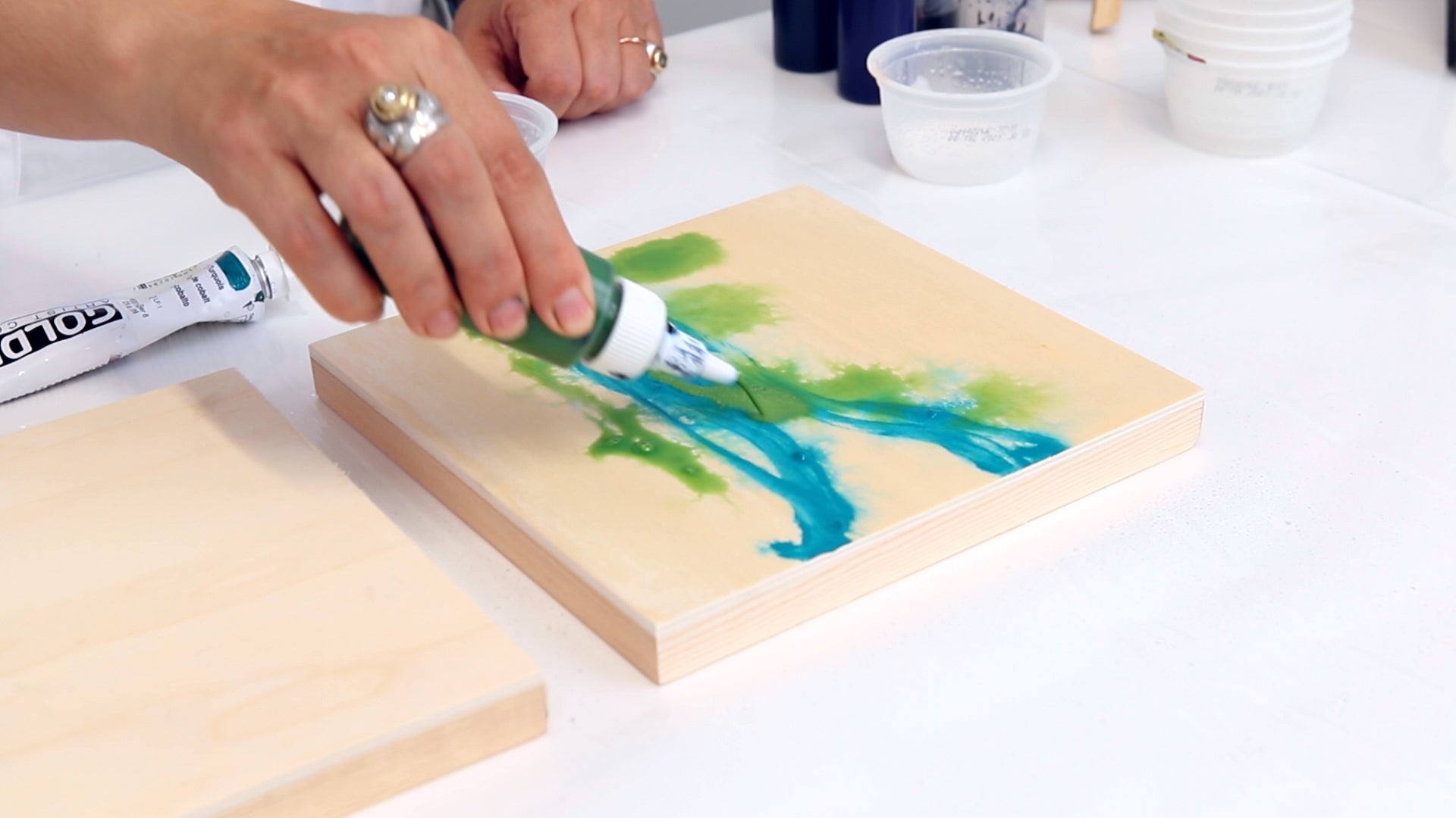 add drops of diluted acrylic paint to panel to create a mixed media painting