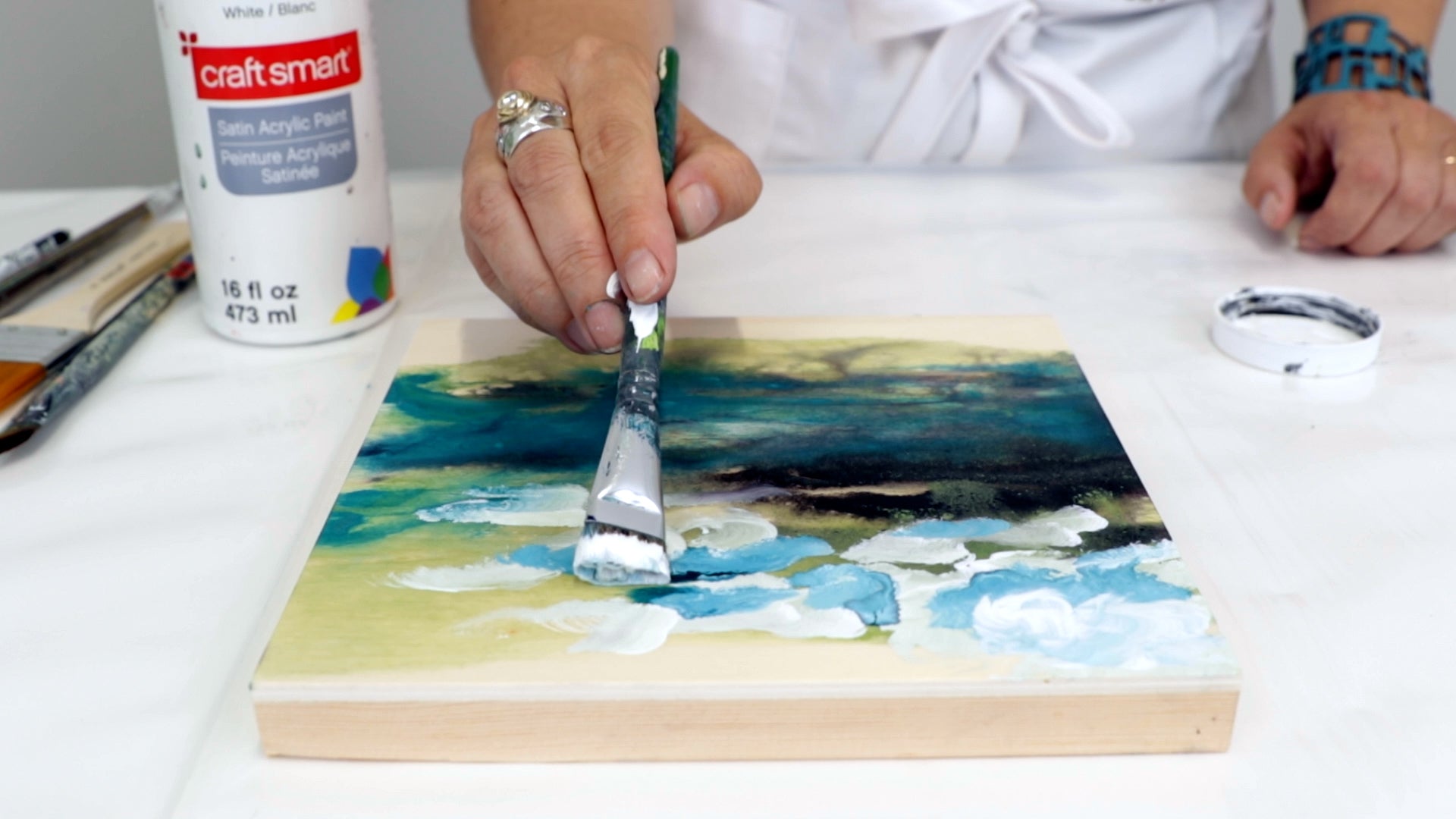 blend in blue dye with white acrylic paint to create clouds