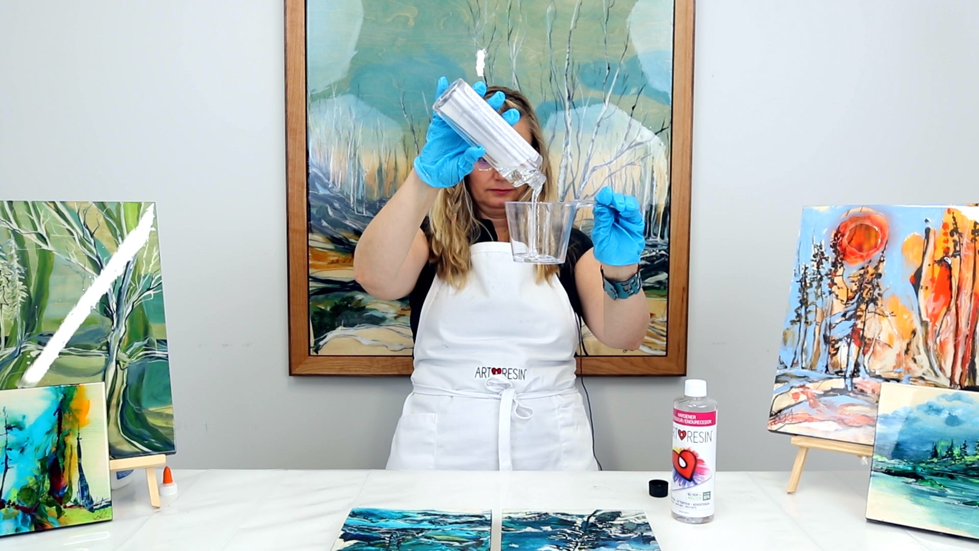 pour resin into measuring cup to resin mixed media painting