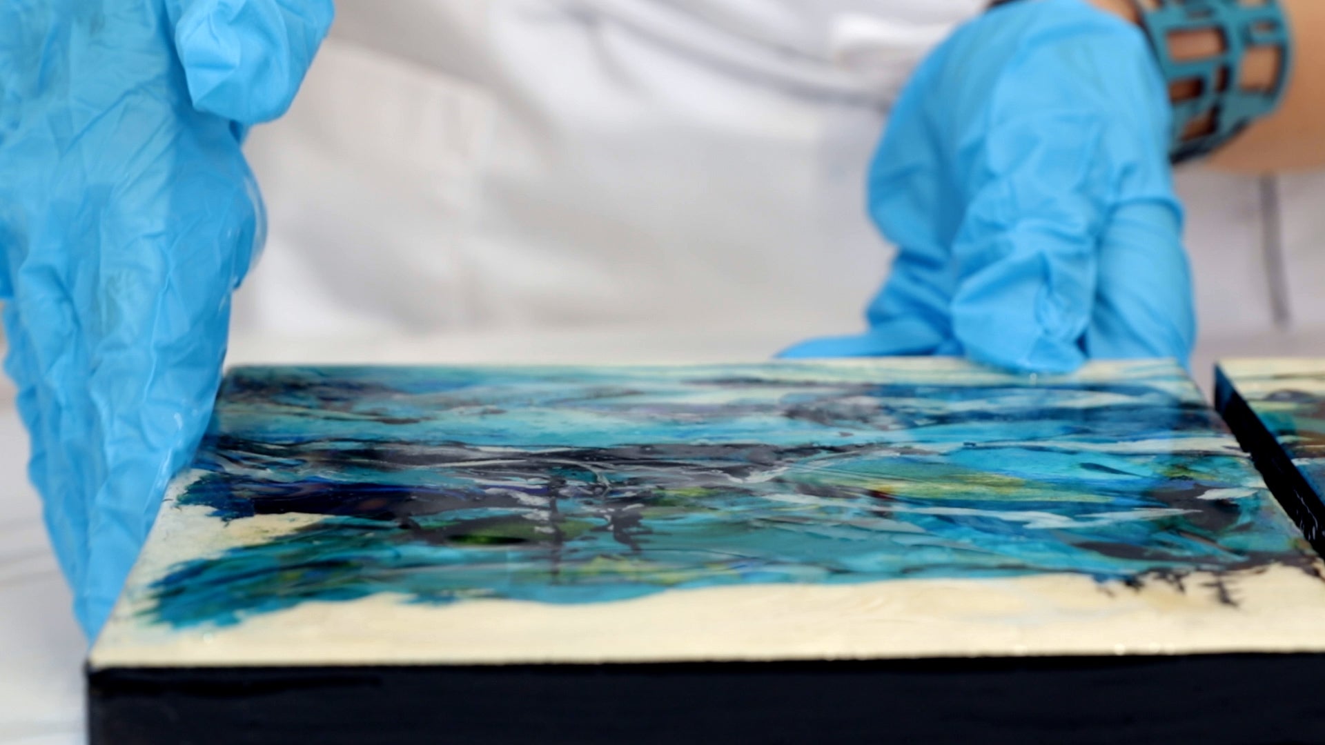 use a gloved hand to spread resin over the edges of the panel