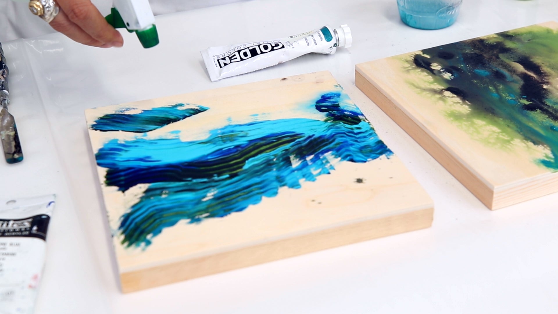 spritz water onto acrylic paint to help paint spread on mixed media painting