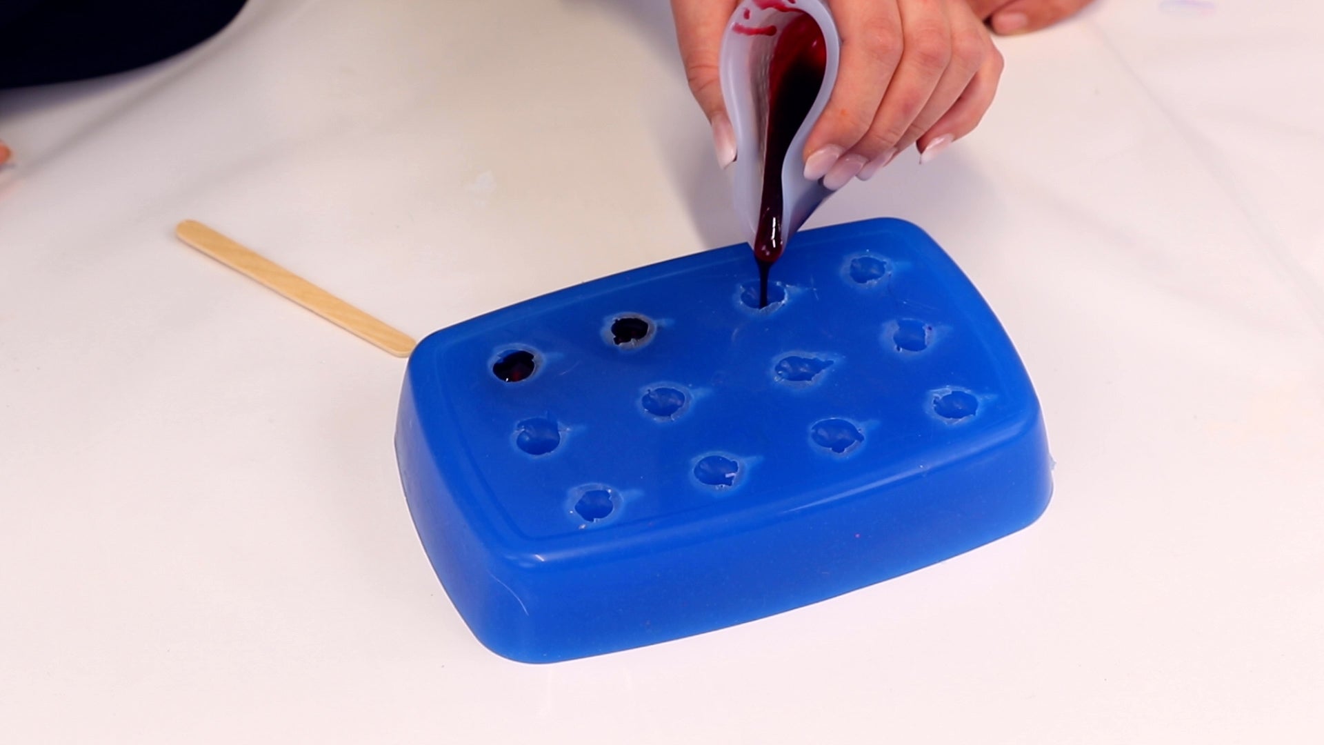 pour liquid gummy syrup into silicone mold