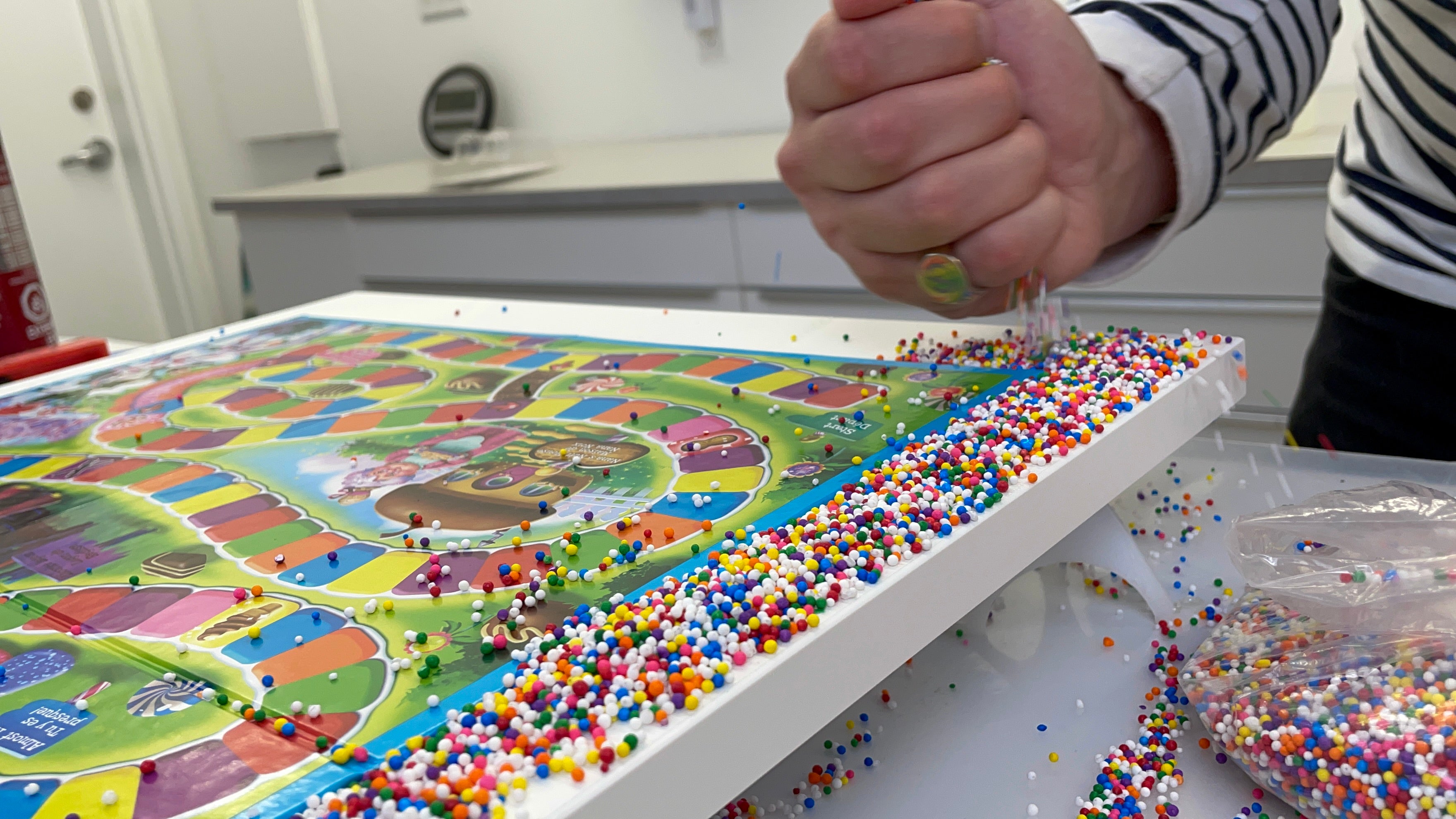 slowly drop candy sprinkles onto board before you resin