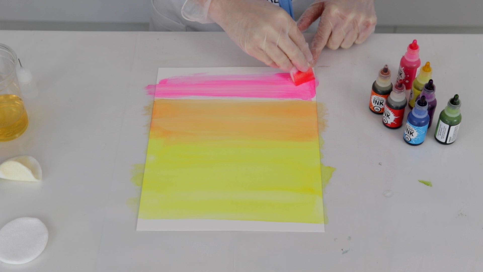 apply pink alcohol ink to create a gradient on yupo paper