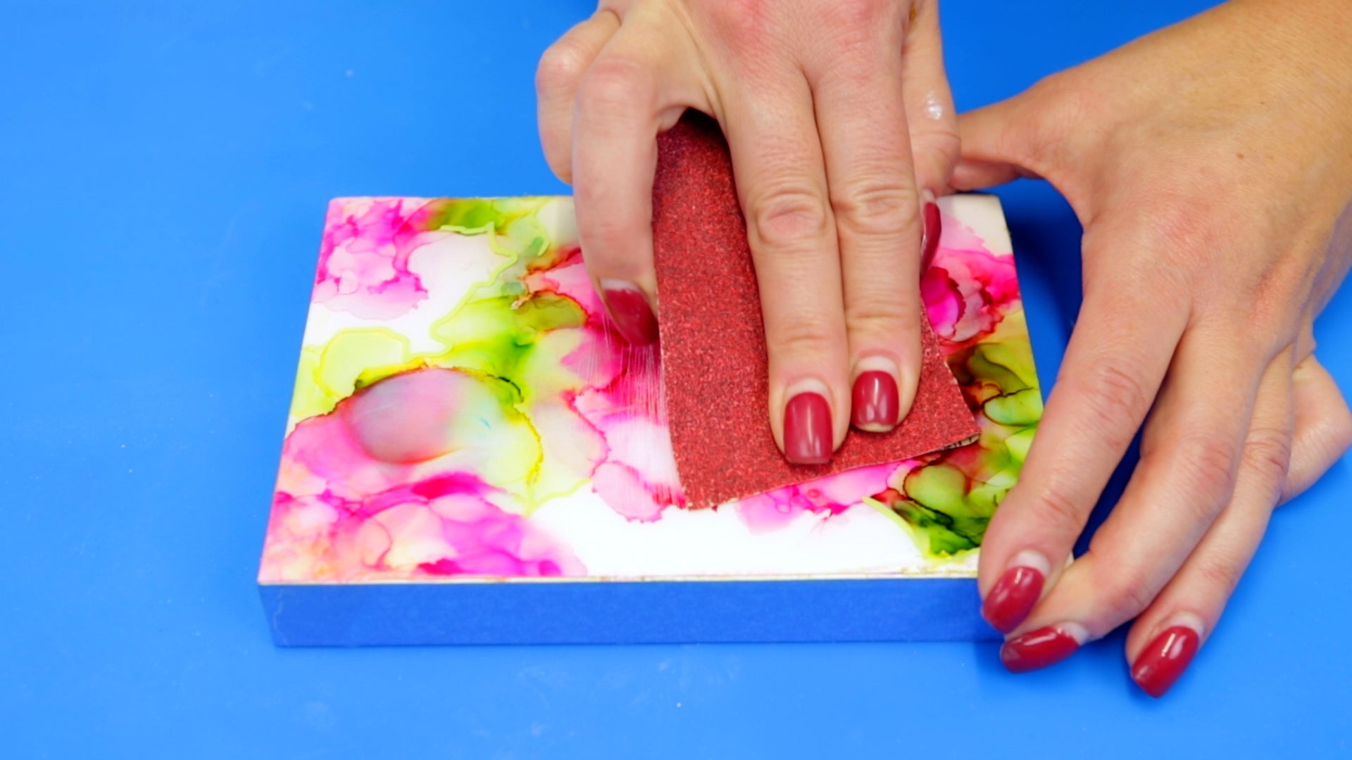 use coarse 80 grit sandpaper to rough up resin before pouring a second layer