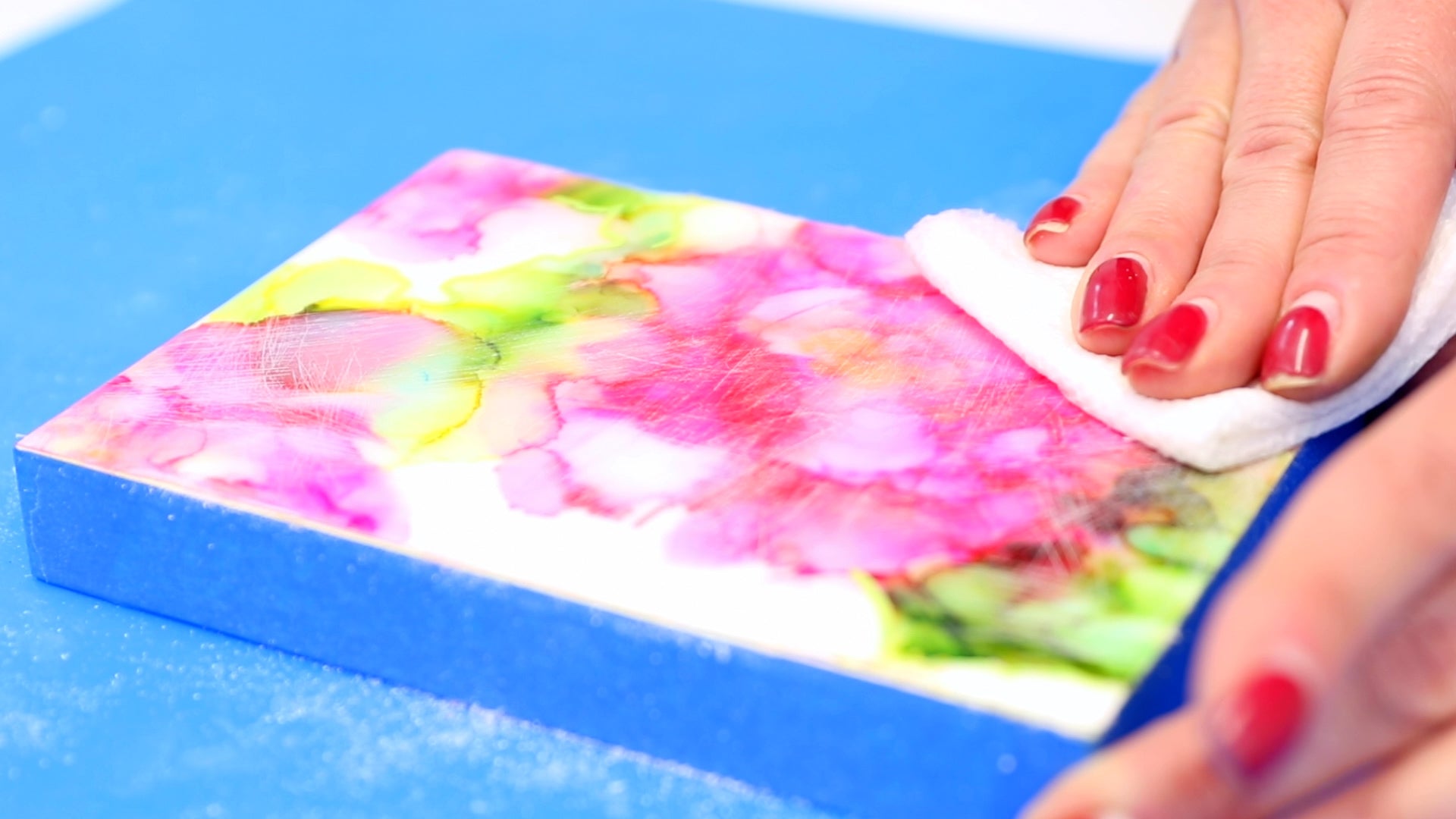 wipe off any sanding residue with damp paper towel before applying fresh resin layer