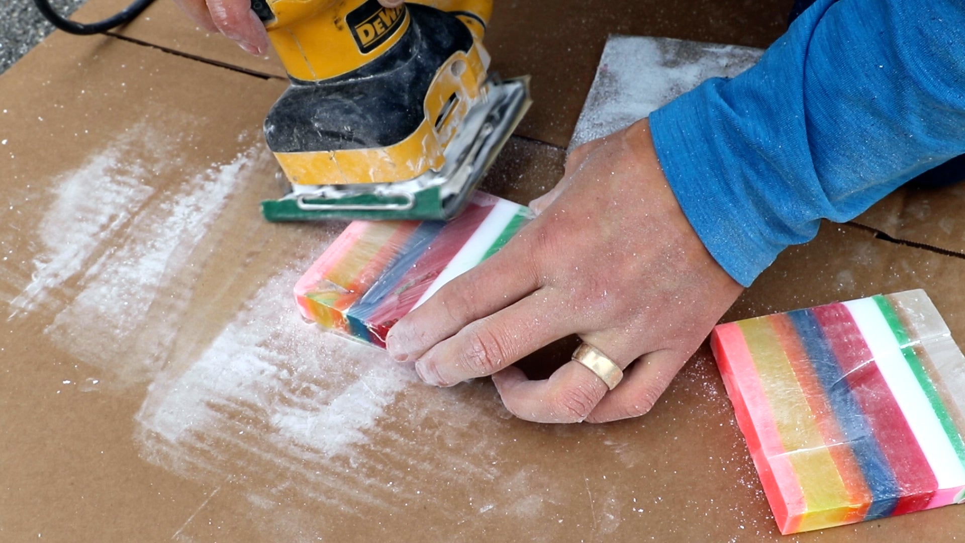 sanding layered resin block into coasters