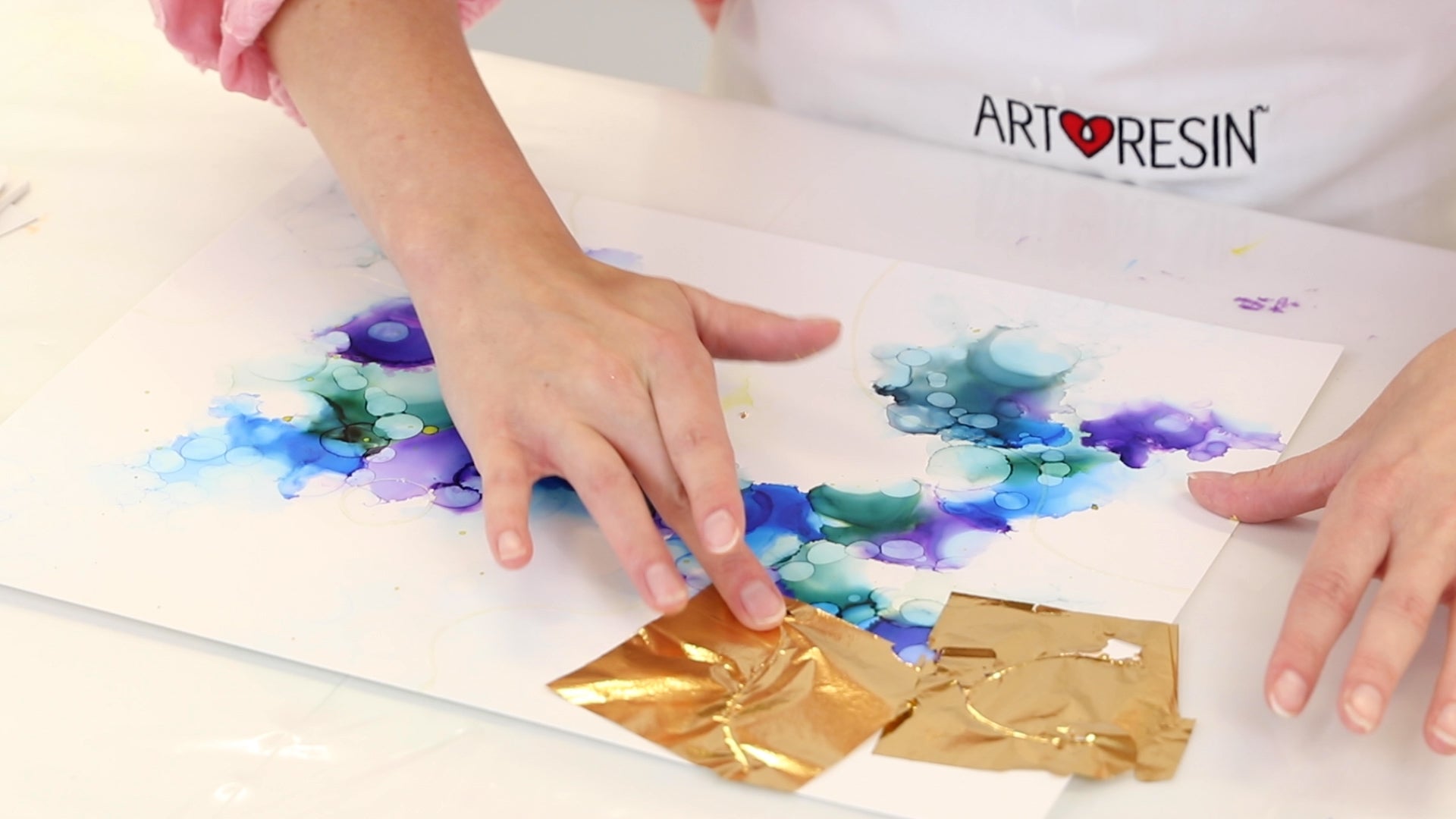 applying gold leaf to alcohol ink abstract painting