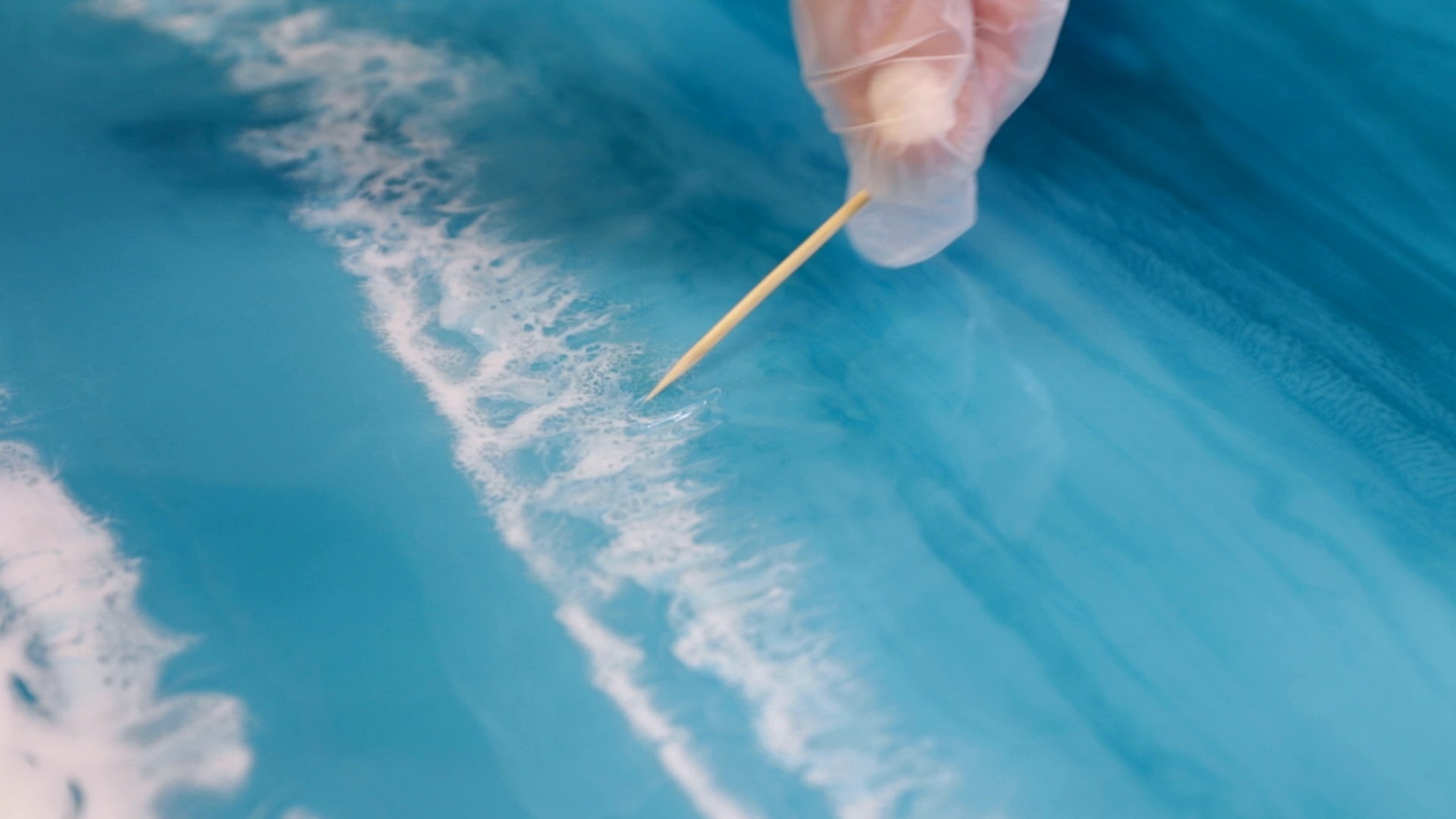 Make Ocean Resin Art - Use a toothpick to drag through the white seafoam