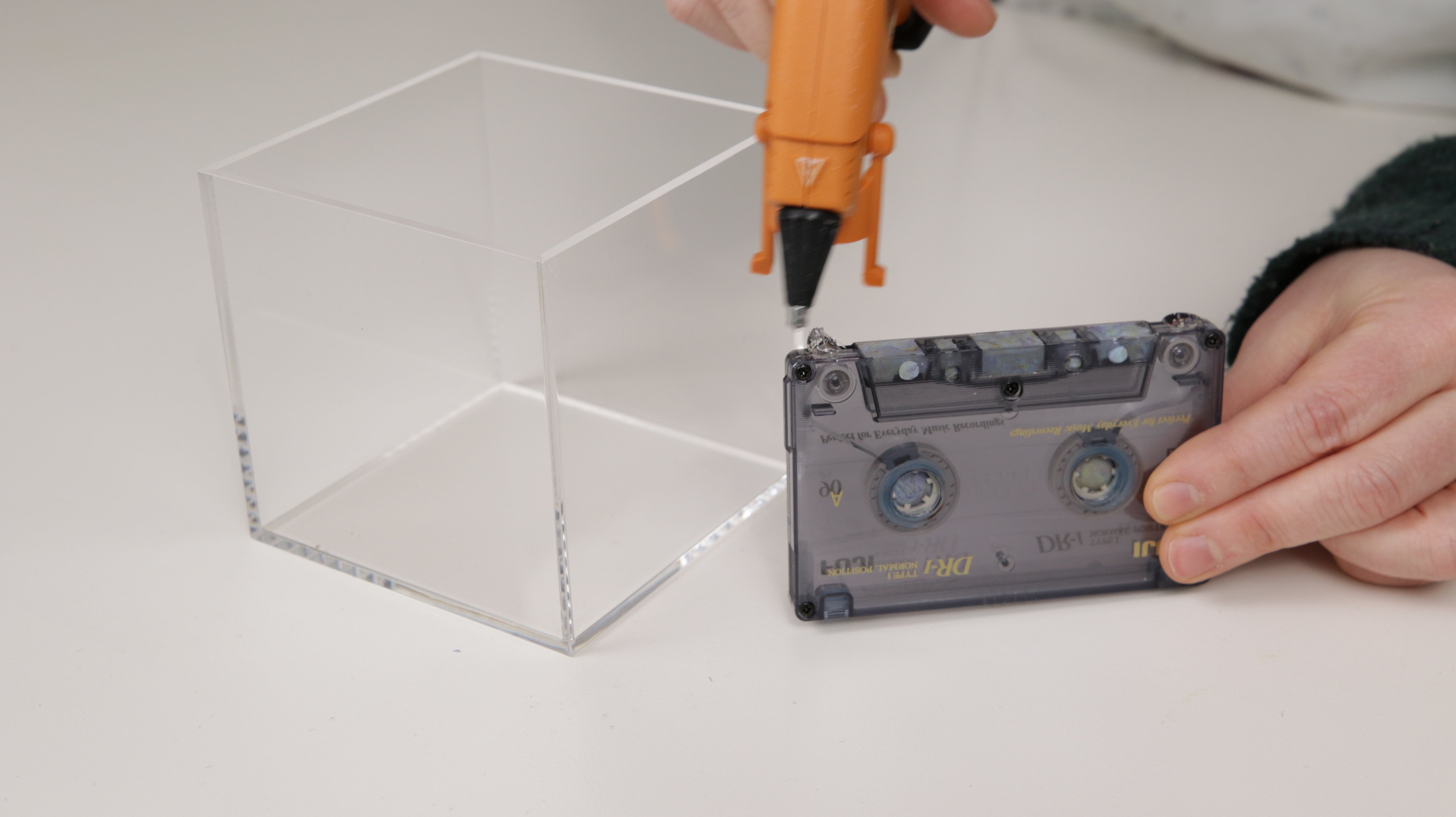 hot glue gun on cassette tape to hold it in place inside mold box