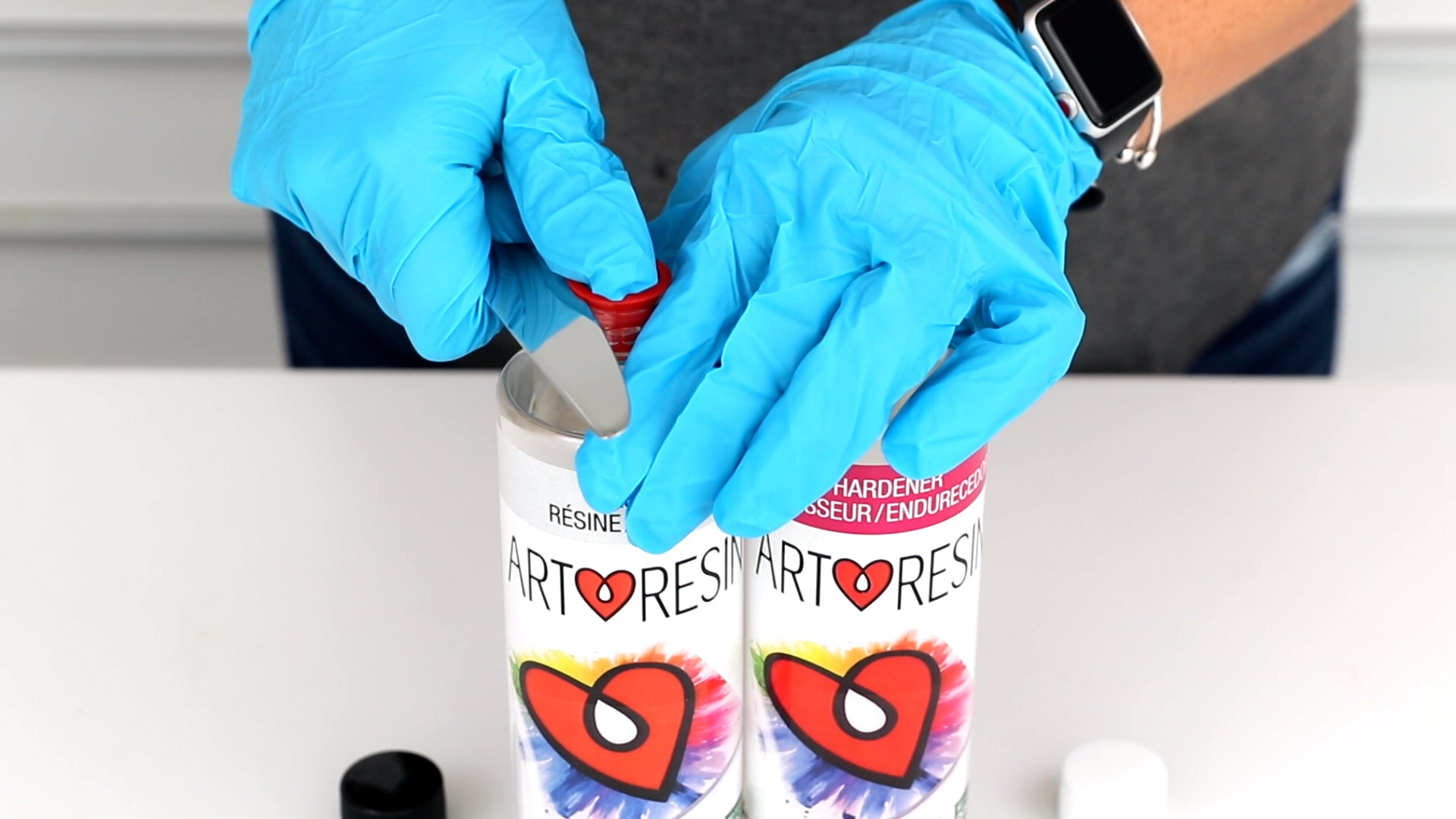 use a knife to pry off red inner caps from artresin bottles