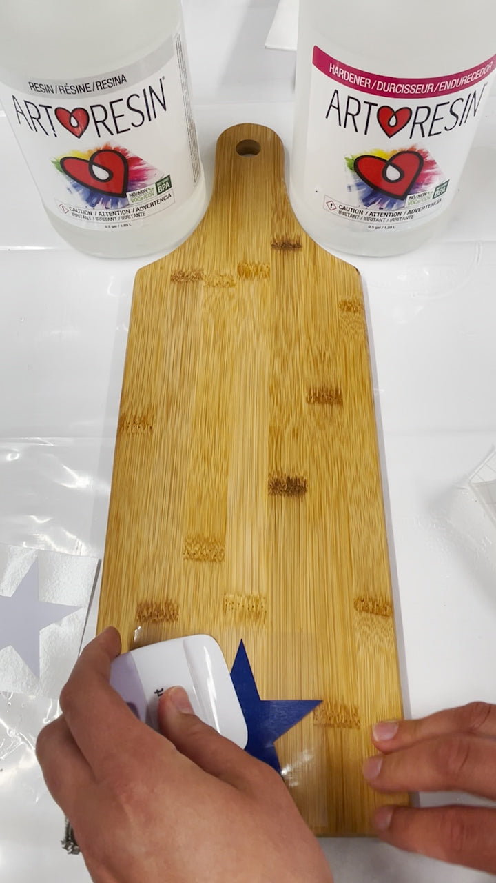 use cricut scraper tool to burnish vinyl decal to wood board and remove air pockets