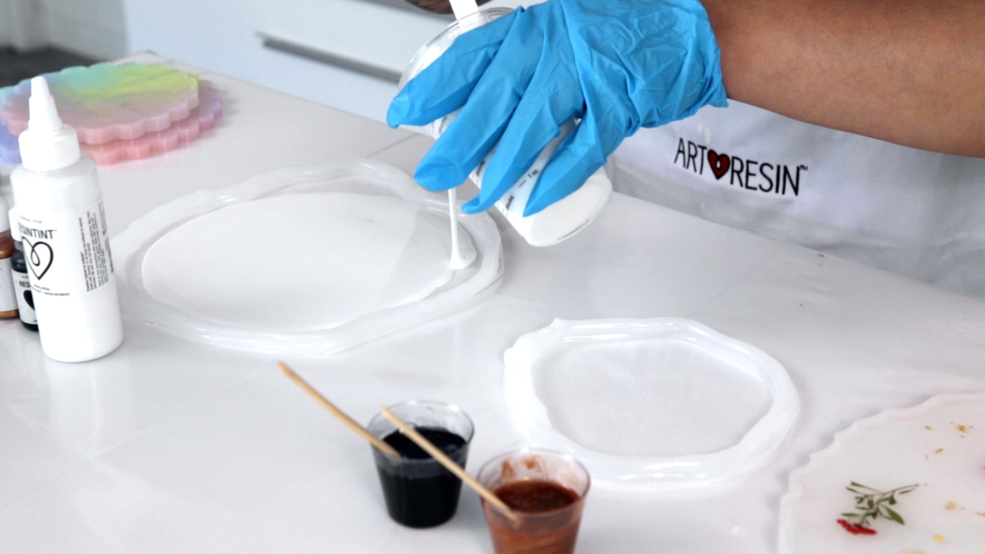 pouring epoxy resin into a coaster mold