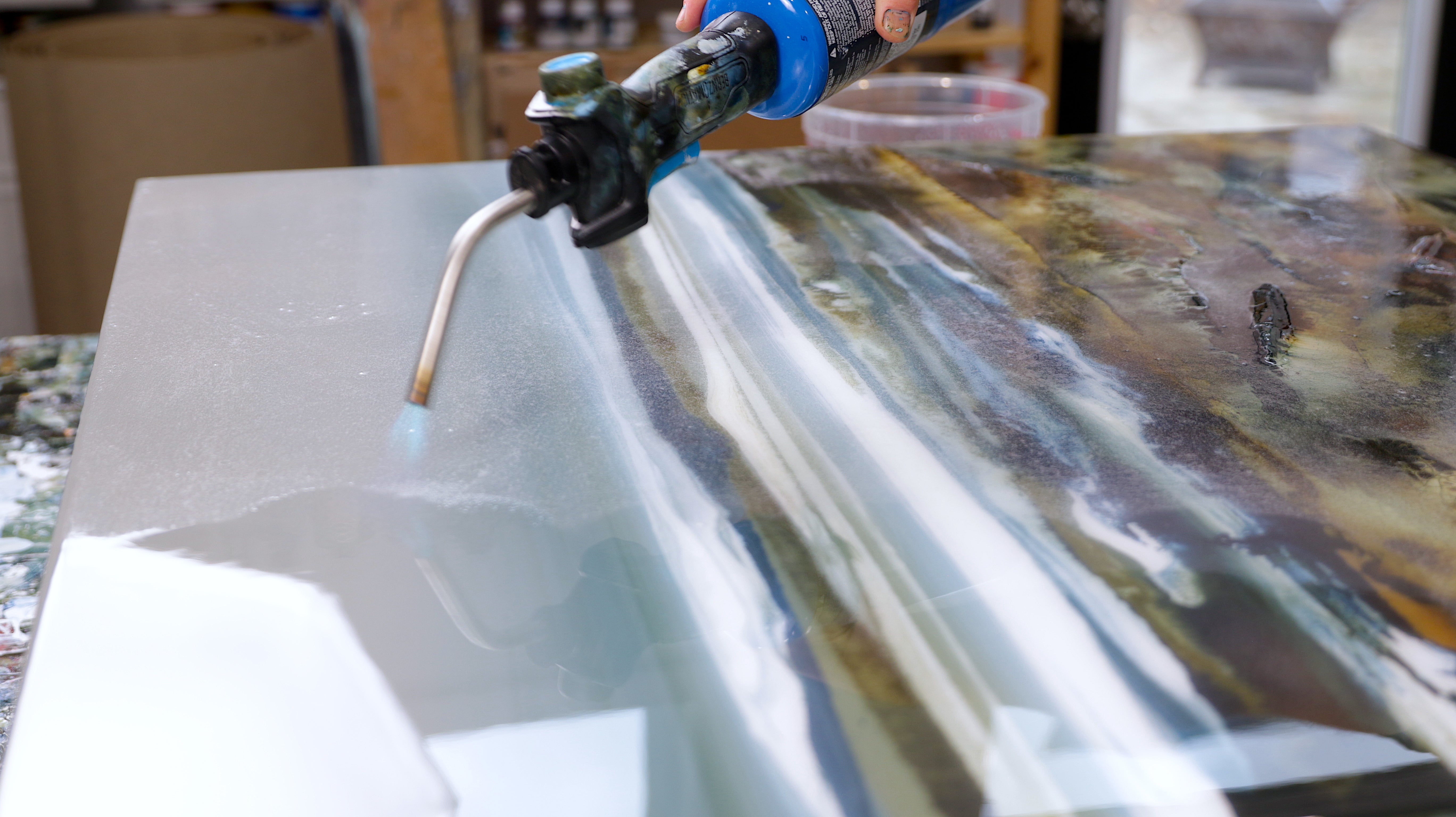 Finish the sides with gloved hands - use a propane torch to remove bubbles from large pieces of resin art