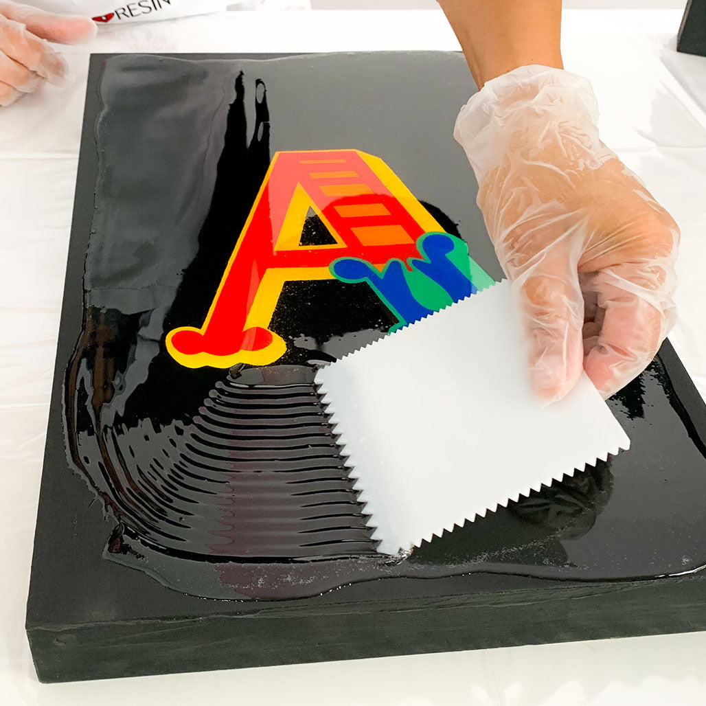 Use a plastic spreader with a flat edge to guide the Artresin