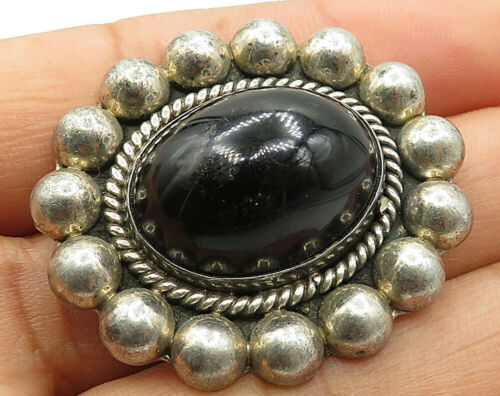 black and silver brooch