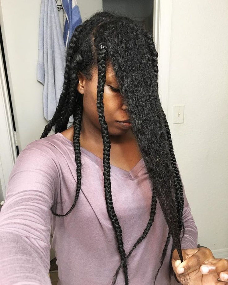 Woman removing braids from natural hair